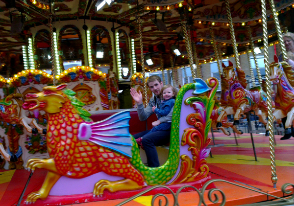 Saturday is caption day, Amy's first ride on a merry-go-round